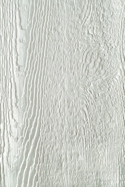 Ljusgrön träpanel med tydlig ådring och textur.