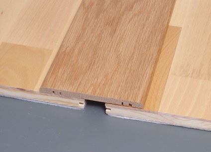 Parkettgolv med en planka i mitten inskjuten i ett omgivande golvmönster.